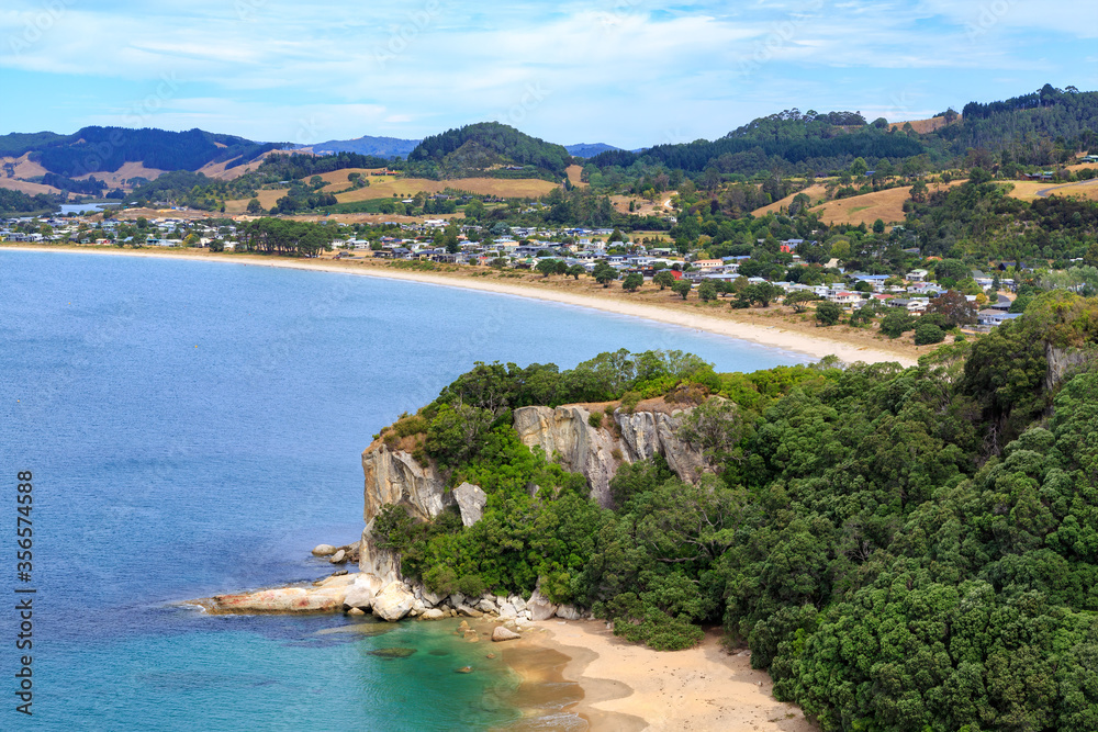 Cooks Beach, a small town on the Coromandel Peninsula, New Zealand, and Lonely Bay (foreground), seen from the Shakespeare Cliff Lookout