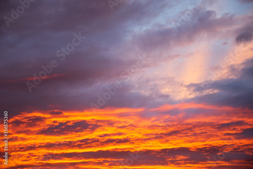 Dramatic sunset vivid orange colored clouds 