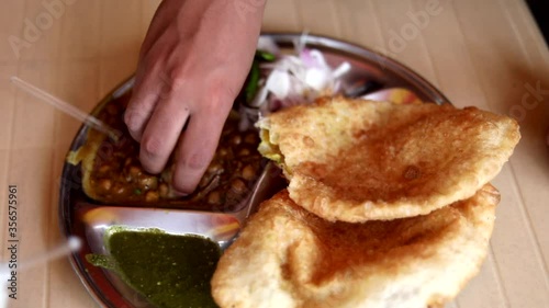 Indian bread Chole Bhature at Darshan with onion in New Delhi, India