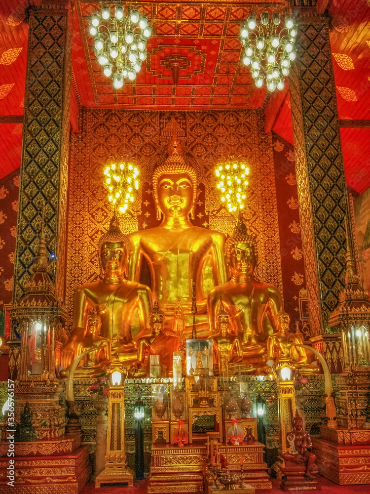 view of Giant Golden Buddha Statue in buddhist temple, Lanna Style Art 13th. Century. Wat Phra That Haripunchai Woramahawihan, Lamphun Province, northern of Thailand.