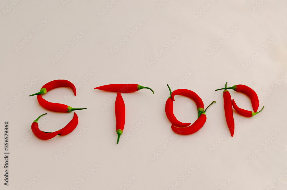 Sign or symbol Stop, made from the fruit of fresh chilli red pepper with a green stalk, Sofia, Bulgaria. Suitable for inclusive education. Sign or symbol Stop, made from the fruit of fresh chilli red pepper with a green stalk, Sofia, Bulgaria. Suitable for inclusive education.