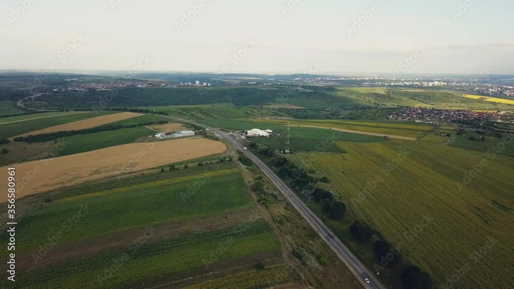 A highway in the middle of endless green fields and trees through which a carrides in rural Moldova. A highway in the middle of endless green fields and trees through which a carrides in rural Moldova.