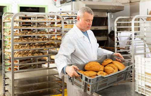Successful baker during daily work in bakeshop