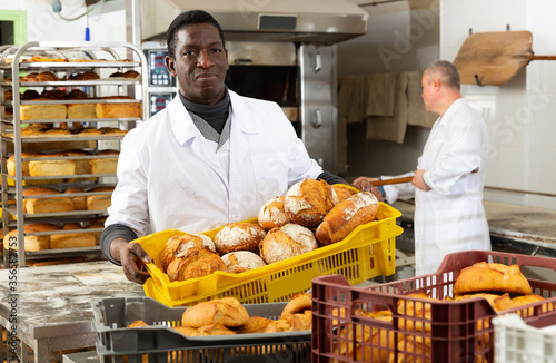 Portrait of successful baker during daily work in bakeshop