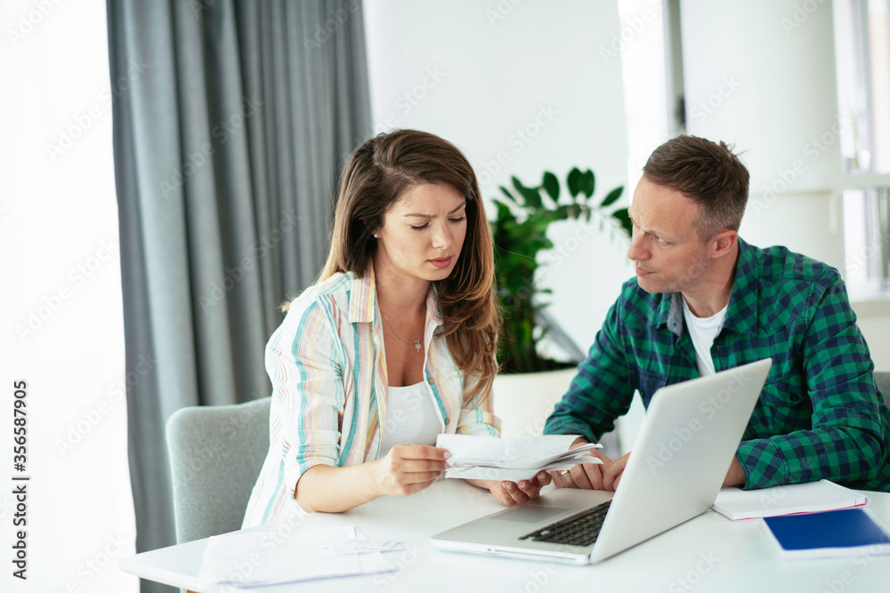 Husband and wife preparing bills to pay. Young couple having financial problems. Husband and wife preparing bills to pay. Young couple having financial problems.