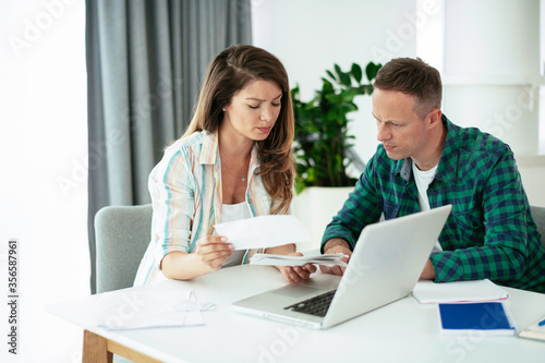 Wallpaper Mural Husband and wife preparing bills to pay. Young couple having financial problems. Torontodigital.ca