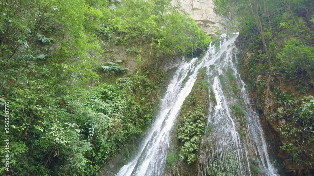 Beautiful scenic waterfall falling down steep high wall of the deep gorge in Wulong National Park, China Beautiful scenic waterfall falling down steep high wall of the deep gorge in Wulong National Park, China