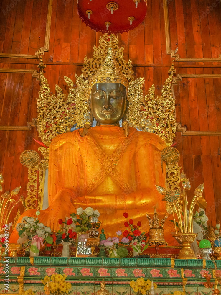view of bronze buddha (Phra Jao Pararakeng) with traditional costume, Yakhai or Myanmar Style art 18th. Century., Wat Hua Wiang, Mae Hong Son, northern of Thailand.