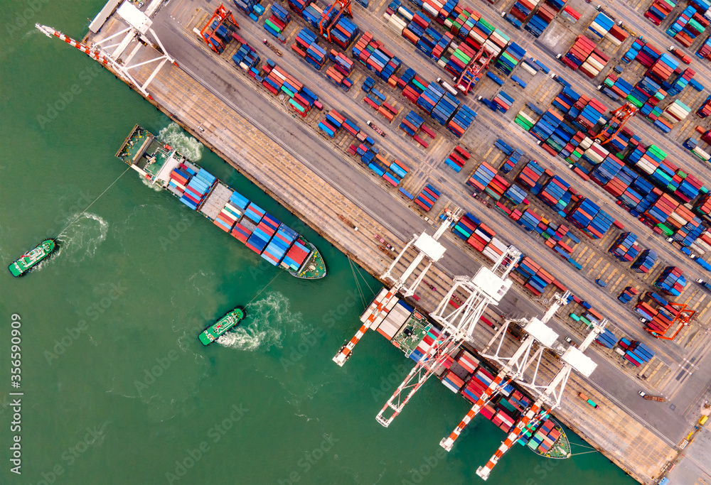 Aerial view of Deep water port with cargo ship and container.