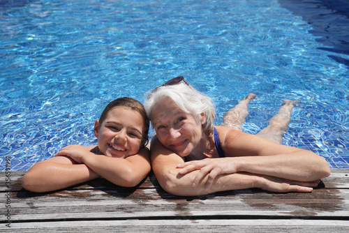 Grandmother with grandkid in resort swimming-pool