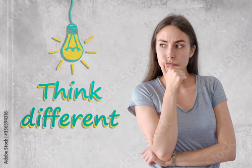 Portrait of wonderful young woman and light bulb for think different concept photo