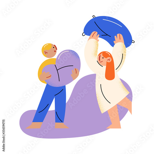 Small brother and sister fighting with pillow and having fun