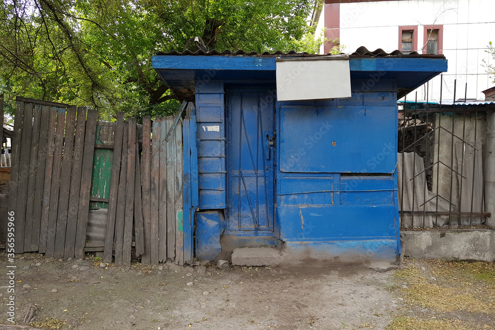 Abandoned blue shopping stall in old district . Frame with copy space . Kyrgyzstan, Bishkek