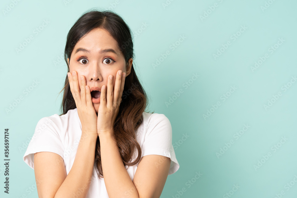 Portrait of young asian people posing shocking and surprising action on blue background with free copy space. Portrait of young asian people posing shocking and surprising action on blue background with free copy space.