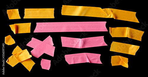 Colorful adhesive paper tape strips, isolated on black background, top view