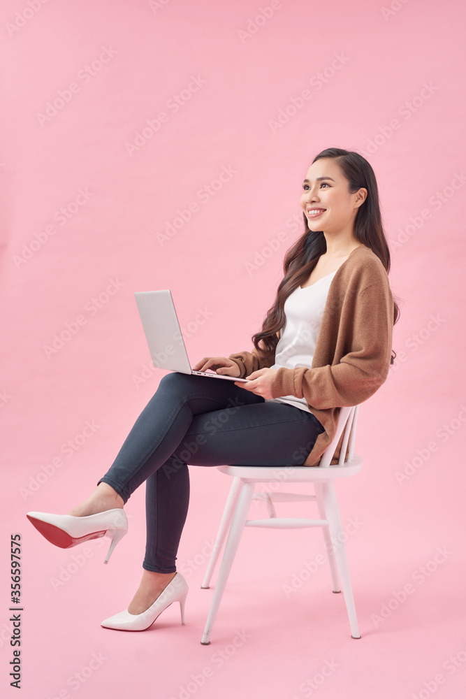 Girl is surfing through the Internet and looking for some interesting information. She is working on her laptop. Girl is surfing through the Internet and looking for some interesting information. She is working on her laptop.