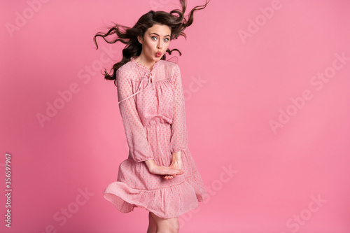 Portrait of astonished pretty charming dream dreamy girl make lips pouted plump impressed air wind blow hair wear polka-dot clothes isolated over pastel color background