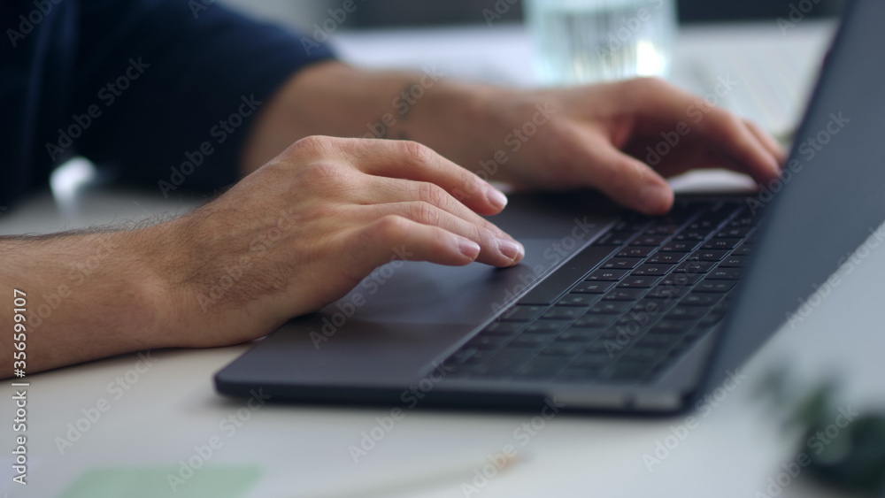 Close up man hands surfing internet on computer. Businessman hands typing laptop Close up man hands surfing internet on computer. Businessman hands typing laptop