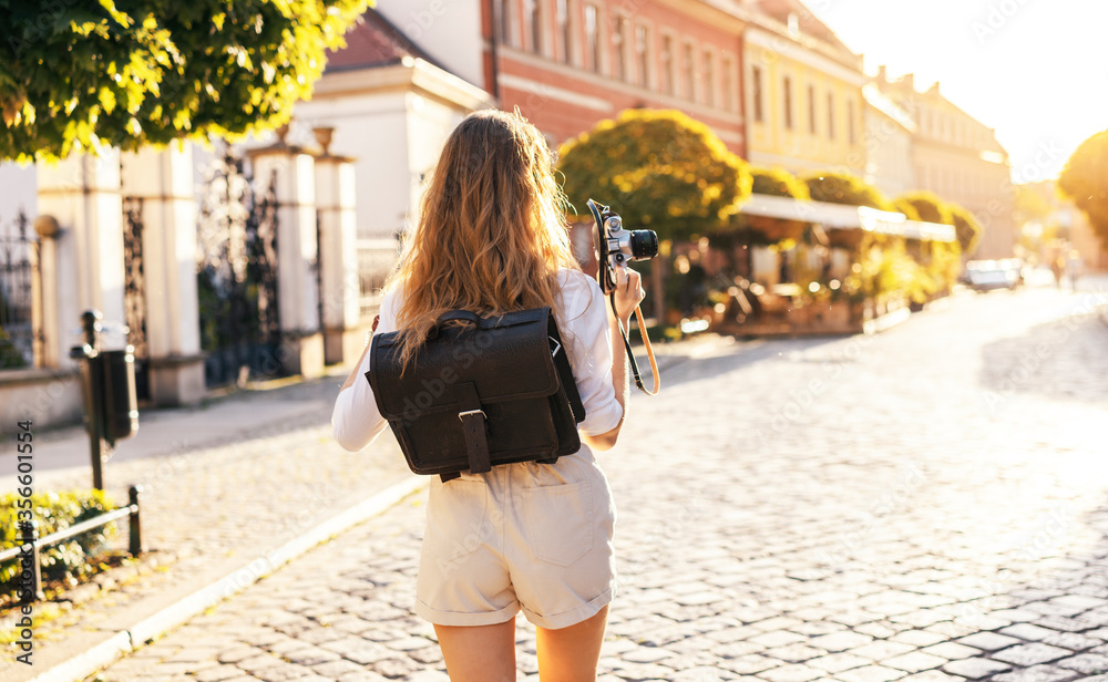 Young blonde tourist is exploring beautiful european city streets Young blonde tourist is exploring beautiful european city streets