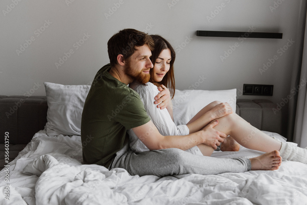 Young man and woman hug and kiss on the bed. Young man and woman hug and kiss on the bed.