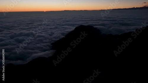Timelapse of sunset above clouds and mountains from Zuluk, Sikkim, India