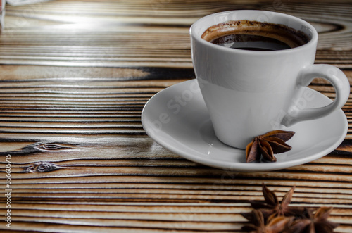 espresso on wooden background with star anise and cinnamon