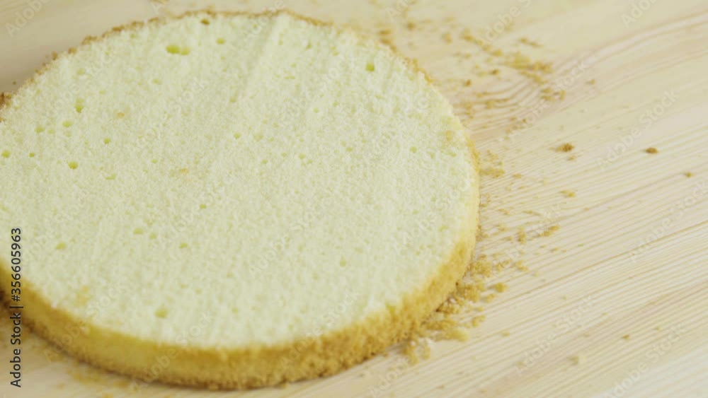 girl divides the sponge cake into 2 equal parts. girl divides the sponge cake into 2 equal parts.