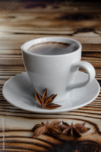 espresso on wooden background with star anise and cinnamon