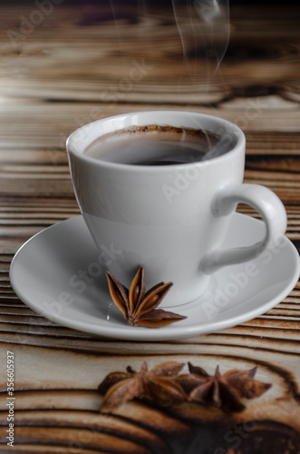 espresso on wooden background with star anise and cinnamon