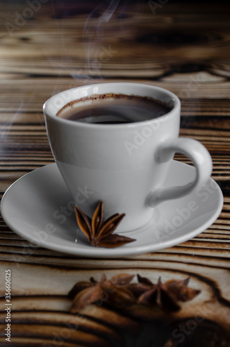 espresso on wooden background with star anise and cinnamon