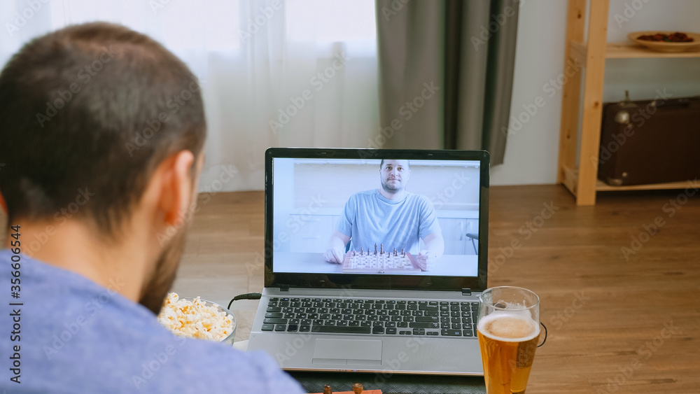 Friends playing chess on video call during covid quarantine. Friends playing chess on video call during covid quarantine.