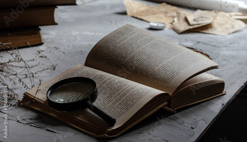 a book on a table with a magnifying glass