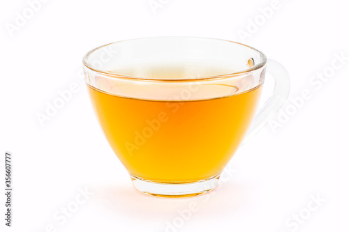 glass of orange herbal tea isolated on white background.
