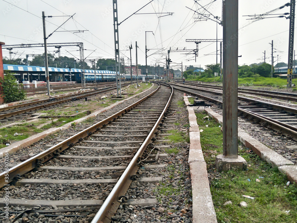 Close Up of Indian Railway Tracks low angel view from a rails sleepers near railway station platform during day time in Howrah Station car shed area. Kolkata India South Asia Pacific March 18, 2020 Close Up of Indian Railway Tracks low angel view from a rails sleepers near railway station platform during day time in Howrah Station car shed area. Kolkata India South Asia Pacific March 18, 2020