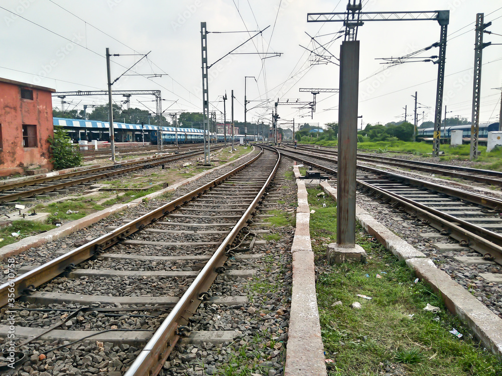 Close Up of Indian Railway Tracks low angel view from a rails sleepers near railway station platform during day time in Howrah Station car shed area. Kolkata India South Asia Pacific March 18, 2020 Close Up of Indian Railway Tracks low angel view from a rails sleepers near railway station platform during day time in Howrah Station car shed area. Kolkata India South Asia Pacific March 18, 2020