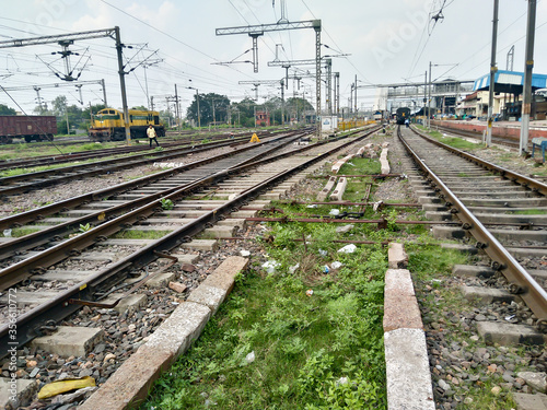 Close Up of Indian Railway Tracks low angel view from a rails sleepers near railway station platform during day time in Howrah Station car shed area. Kolkata India South Asia Pacific March 18, 2020