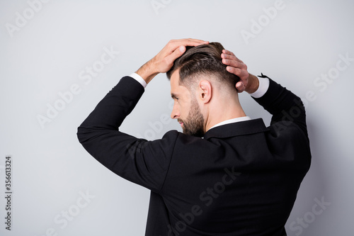 Back rear profile side photo of serious handsome worker man touch silky hair after haircare barber shop treatment partnership meeting wear black blazer isolated grey color background