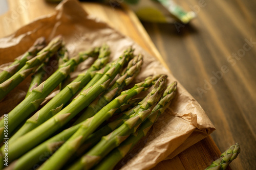 Fresh asparagus on rustic wooden background