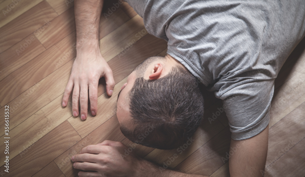 Fototapeta premium Caucasian unconscious man at home.