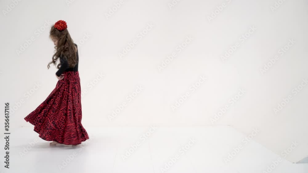 Beautiful girl in a long dress dancing with outstretched hand Beautiful girl in a long dress dancing with outstretched hand