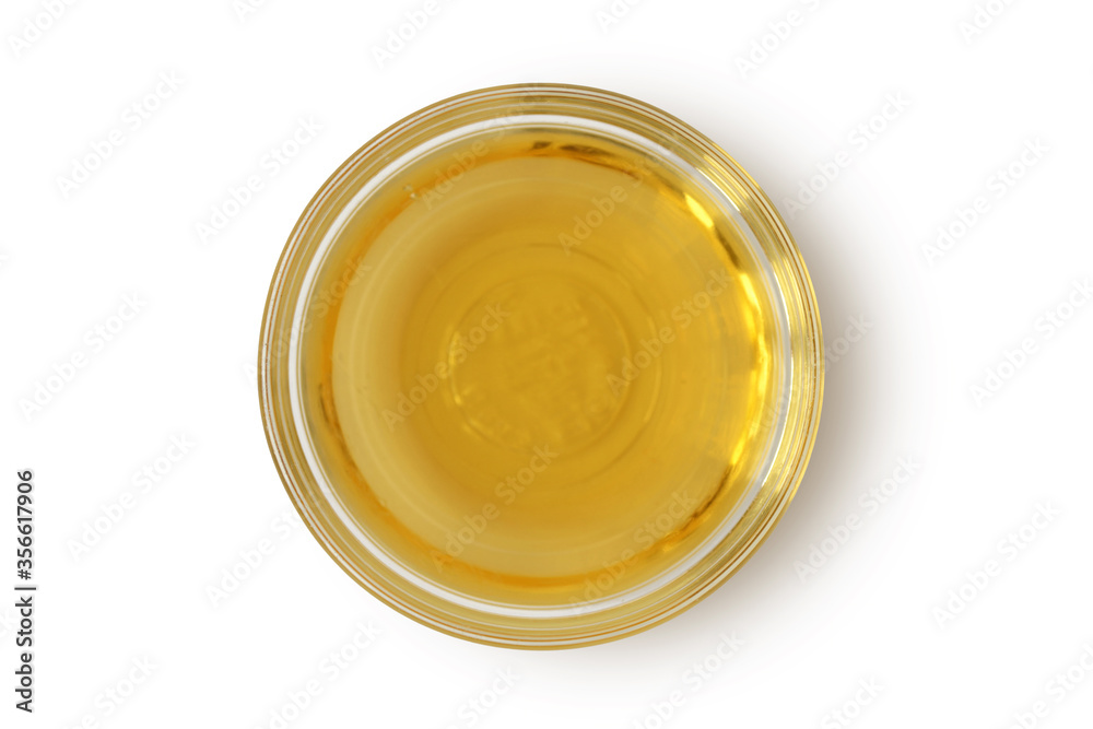 Apple cider vinegar in glass bowl on white background Apple cider vinegar in glass bowl on white background