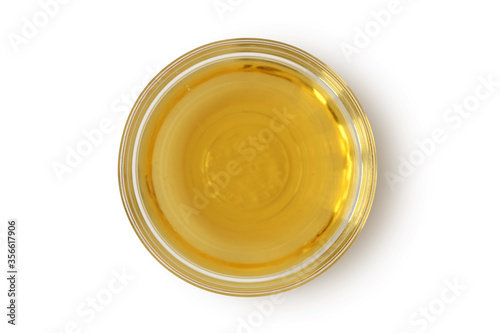 Apple cider vinegar in glass bowl on white background photo