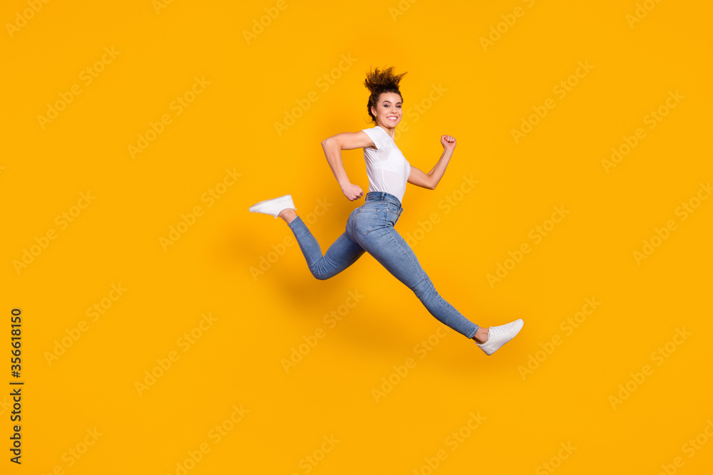 Full length body size view of her she nice attractive lovely sporty cheerful cheery girl jumping running marathon distance isolated on bright vivid shine vibrant yellow color background