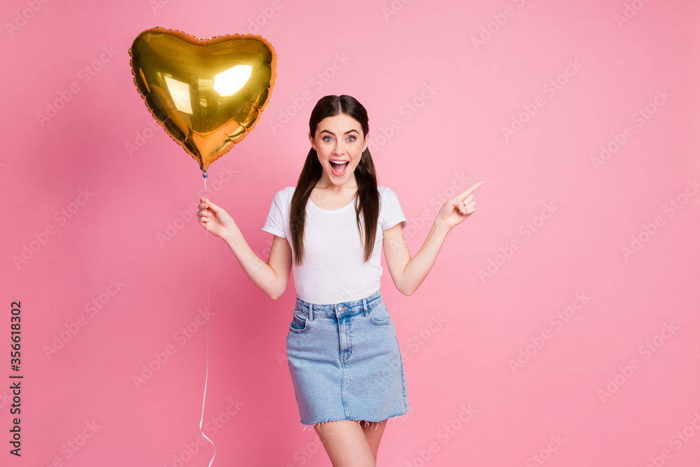 Portrait of nice attractive lovely charming cheerful cheery straight-haired girl holding in hand helium ball showing copy space ad advert isolated over pink pastel color background Portrait of nice attractive lovely charming cheerful cheery straight-haired girl holding in hand helium ball showing copy space ad advert isolated over pink pastel color background