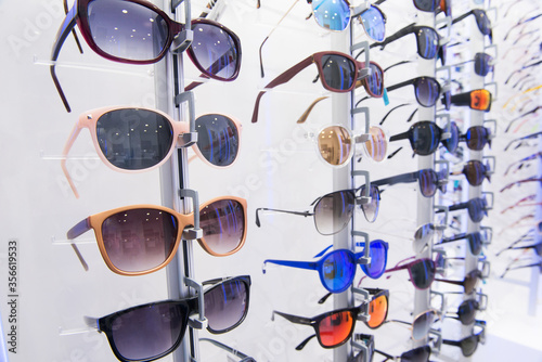 Showcase with sunglasses in modern optic store