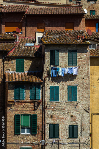 Streets and houses and sculptues in Siena Italy