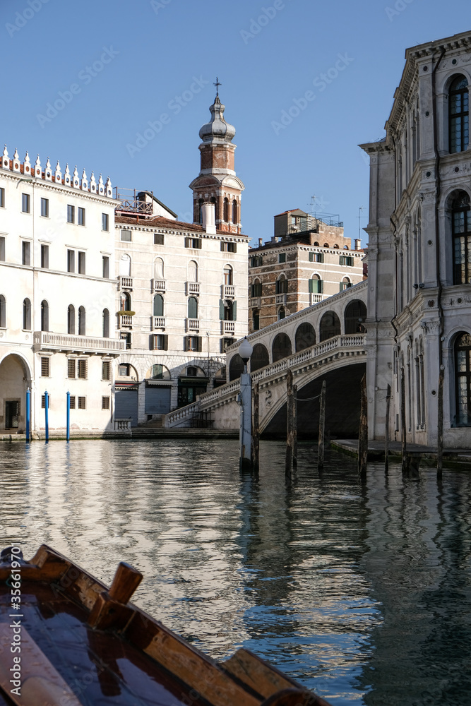 Venice, Italy. View of Rialto's Bridge with no tourists from a traditional venetian boat during coronavirus outbreak.