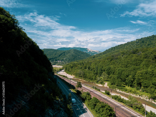Aerial view of highway and railway between the greenmountains photo