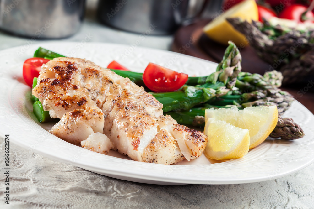 Fried cod fillet with green asparagus Fried cod fillet with green asparagus