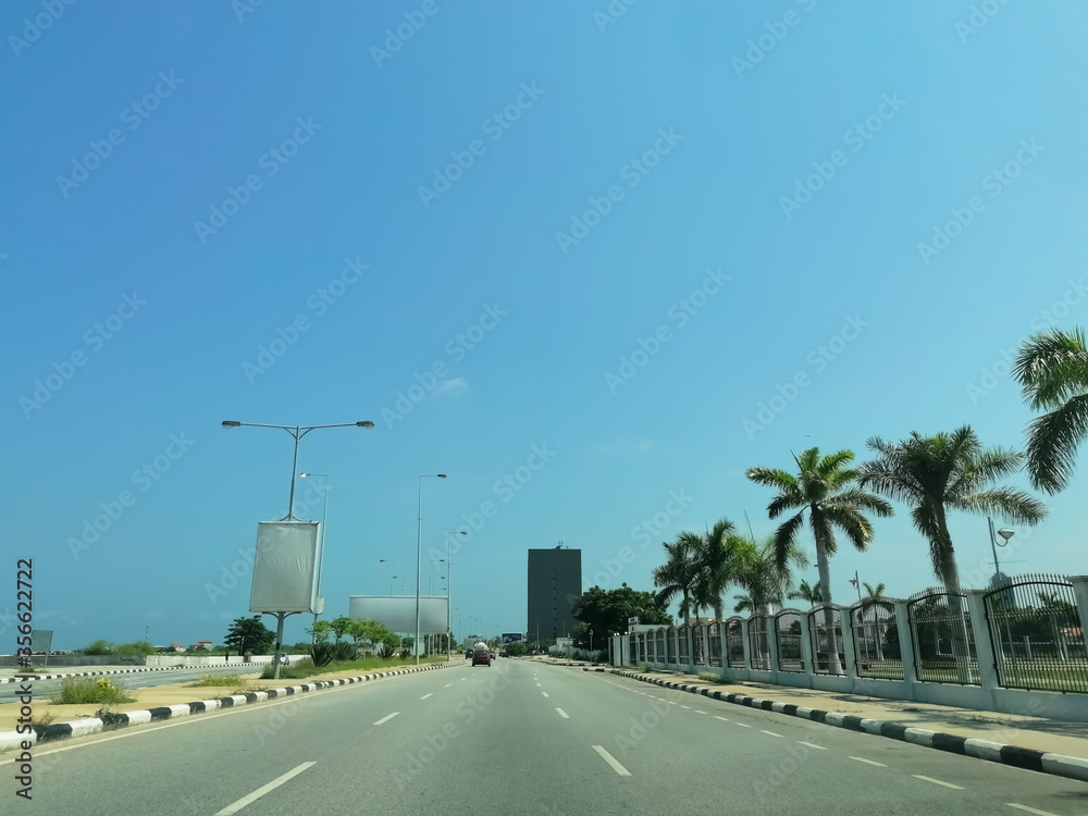 View of marginal Luanda road in the Luanda city downtown center with road, vehicles and buildings View of marginal Luanda road in the Luanda city downtown center with road, vehicles and buildings